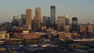 5.7K aerial stock footage of slowly flying away from the city's downtown skyline at sunset in Downtown Minneapolis, Minnesota Aerial Stock Footage | DX0001_002226