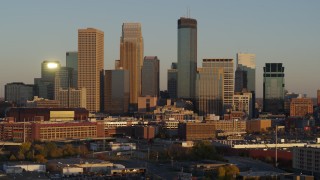 5.7K aerial stock footage ascend to flyby the city's downtown skyline at sunset, Downtown Minneapolis, Minnesota Aerial Stock Footage | DX0001_002230