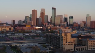 DX0001_002236 - 5.7K aerial stock footage flyby the city's skyline at sunset during ascent, Downtown Minneapolis, Minnesota