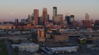 5.7K aerial stock footage of the city's skyline and moon at sunset, seen from marketplace, Downtown Minneapolis, Minnesota Aerial Stock Footage | DX0001_002238