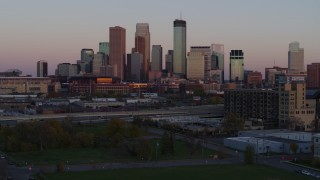 5.7K aerial stock footage approach city's skyline at sunset from park, Downtown Minneapolis, Minnesota Aerial Stock Footage | DX0001_002243