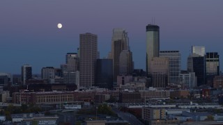 5.7K aerial stock footage ascend with view of moon near the city's downtown skyline at twilight, Downtown Minneapolis, Minnesota Aerial Stock Footage | DX0001_002259