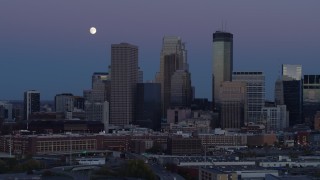 5.7K aerial stock footage of moon above the city's downtown skyline at twilight, Downtown Minneapolis, Minnesota Aerial Stock Footage | DX0001_002260