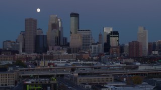 5.7K aerial stock footage flyby the city's skyline with the moon in the sky at twilight, Downtown Minneapolis, Minnesota Aerial Stock Footage | DX0001_002265