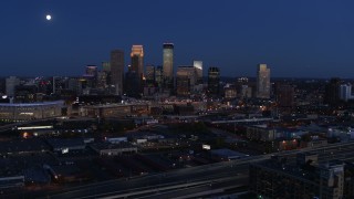 5.7K aerial stock footage passing the moon above city skyline at twilight, Downtown Minneapolis, Minnesota Aerial Stock Footage | DX0001_002277