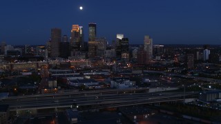 5.7K aerial stock footage of a view of the moon above city's downtown skyline at twilight, Downtown Minneapolis, Minnesota Aerial Stock Footage | DX0001_002279