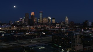 5.7K aerial stock footage ascend to approach moon above city's skyline at twilight, Downtown Minneapolis, Minnesota Aerial Stock Footage | DX0001_002287