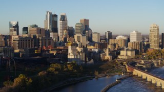 5.7K aerial stock footage flyby smoke stacks for view of skyline across the river at sunrise, Downtown Minneapolis, Minnesota Aerial Stock Footage | DX0001_002311