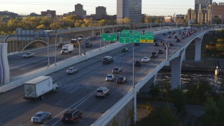 DX0001_002314 - 5.7K aerial stock footage of traffic backing up on a bridge at sunrise, Minneapolis, Minnesota