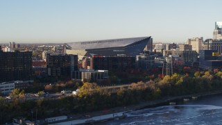 5.7K aerial stock footage of US Bank Stadium at sunrise, seen while descending across the river, Downtown Minneapolis, Minnesota Aerial Stock Footage | DX0001_002323