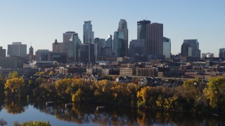 5.7K aerial stock footage of the skyline seen during ascent by the river, Downtown Minneapolis, Minnesota Aerial Stock Footage | DX0001_002332