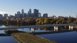 5.7K aerial stock footage approach and fly over bridge and river, focus on skyline of Downtown Minneapolis, Minnesota Aerial Stock Footage | DX0001_002339