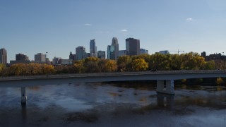 5.7K aerial stock footage approach and fly over bridge spanning river with view of city skyline, Downtown Minneapolis, Minnesota Aerial Stock Footage | DX0001_002451