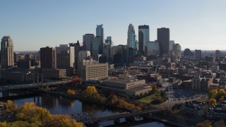 5.7K aerial stock footage flying by the river with view of the city skyline, Downtown Minneapolis, Minnesota Aerial Stock Footage | DX0001_002487