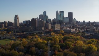 5.7K aerial stock footage of flying by fall trees and the city skyline, Downtown Minneapolis, Minnesota Aerial Stock Footage | DX0001_002489