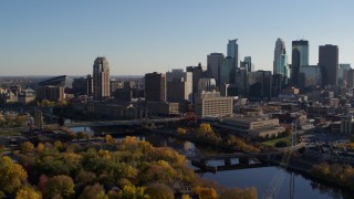 5.7K aerial stock footage reverse view of residential skyscraper near bridge spanning the river, Downtown Minneapolis, Minnesota Aerial Stock Footage | DX0001_002494