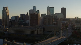 5.7K aerial stock footage fly away from Hennepin Avenue Bridge and apartment buildings at sunset in Downtown Minneapolis, Minnesota Aerial Stock Footage | DX0001_002503