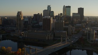 5.7K aerial stock footage fly by Hennepin Avenue Bridge and apartment buildings at sunset in Downtown Minneapolis, Minnesota Aerial Stock Footage | DX0001_002504