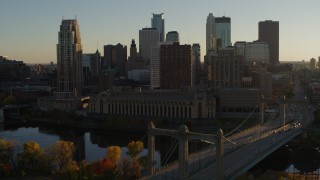 5.7K aerial stock footage descend by Hennepin Avenue Bridge and apartment buildings at sunset in Downtown Minneapolis, Minnesota Aerial Stock Footage | DX0001_002505