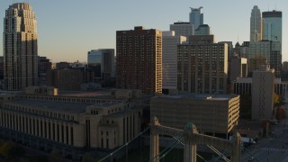 5.7K aerial stock footage of post office and apartment buildings at sunset near bridge, Downtown Minneapolis, Minnesota Aerial Stock Footage | DX0001_002508