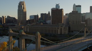 5.7K aerial stock footage fly away from post office and apartment buildings at sunset near bridge, Downtown Minneapolis, Minnesota Aerial Stock Footage | DX0001_002509