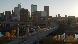 5.7K aerial stock footage flyby Hennepin Avenue Bridge at sunset, with view of Downtown Minneapolis, Minnesota Aerial Stock Footage | DX0001_002510