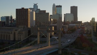 5.7K aerial stock footage flyby and approach Hennepin Avenue Bridge at sunset near apartment buildings, Downtown Minneapolis, Minnesota Aerial Stock Footage | DX0001_002511