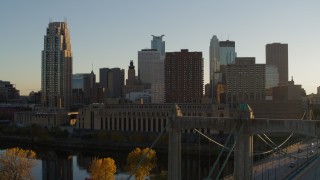 5.7K aerial stock footage ascend by Hennepin Avenue Bridge, USPS and apartment buildings at sunset, Downtown Minneapolis, Minnesota Aerial Stock Footage | DX0001_002517