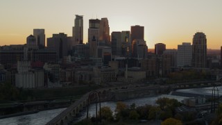 5.7K aerial stock footage of city skyline across the Mississippi River at sunset, reveal power plant, Downtown Minneapolis, Minnesota Aerial Stock Footage | DX0001_002534