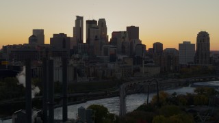 5.7K aerial stock footage flyby river with view of city skyline in background at sunset, reveal power plant, Downtown Minneapolis, Minnesota Aerial Stock Footage | DX0001_002539