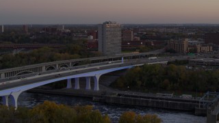 5.7K aerial stock footage fly away from a condo complex beside a bridge at sunset, Minneapolis, Minnesota Aerial Stock Footage | DX0001_002550