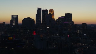 DX0001_002572 - 5.7K aerial stock footage ascend by the skyscrapers in the city skyline at twilight, Downtown Minneapolis, Minnesota