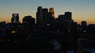 5.7K aerial stock footage descend by the city skyline lit for the night at twilight, Downtown Minneapolis, Minnesota Aerial Stock Footage | DX0001_002582