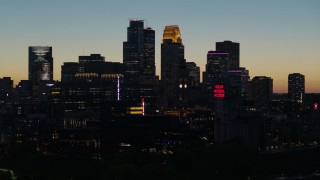 5.7K aerial stock footage descend and flyby the city skyline lit for the night at twilight, Downtown Minneapolis, Minnesota Aerial Stock Footage | DX0001_002585