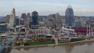 5.7K aerial stock footage ascend and fly away from city skyline and baseball stadium by Ohio River, Downtown Cincinnati, Ohio Aerial Stock Footage | DX0001_002596