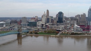 5.7K aerial stock footage of a view of the city skyline and bridge by Ohio River during descent, Downtown Cincinnati, Ohio Aerial Stock Footage | DX0001_002599