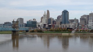 5.7K aerial stock footage descend near bridge spanning Ohio River and focus on skyline of Downtown Cincinnati, Ohio Aerial Stock Footage | DX0001_002602