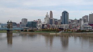 5.7K aerial stock footage reverse view of skyline while flying low over Ohio River, Downtown Cincinnati, Ohio Aerial Stock Footage | DX0001_002603