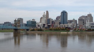 5.7K aerial stock footage flying by city skyline while flying low over Ohio River, Downtown Cincinnati, Ohio Aerial Stock Footage | DX0001_002604