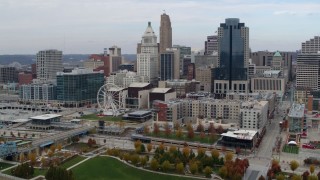 DX0001_002606 - 5.7K aerial stock footage flyby Ferris wheel and apartment building near skyscrapers, Downtown Cincinnati, Ohio