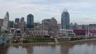 DX0001_002614 - 5.7K aerial stock footage ascend and flyby riverfront baseball stadium and skyline, reveal bridge, Downtown Cincinnati, Ohio