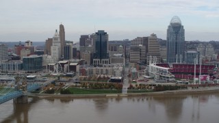 5.7K aerial stock footage flyby a riverfront baseball stadium and skyline while ascending over river, Downtown Cincinnati, Ohio Aerial Stock Footage | DX0001_002620