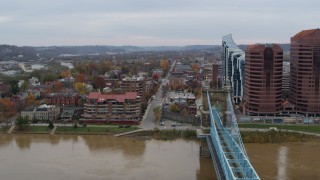 5.7K aerial stock footage of flying by a bridge for view of two riverfront office buildings in Covington, Kentucky Aerial Stock Footage | DX0001_002628