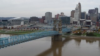 5.7K aerial stock footage fly away from the Roebling Bridge spanning Ohio River near the city skyline, Downtown Cincinnati, Ohio Aerial Stock Footage | DX0001_002639