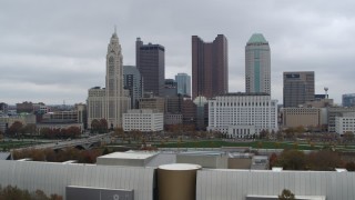 5.7K aerial stock footage ascend near science museum for view of city's skyline, Downtown Columbus, Ohio Aerial Stock Footage | DX0001_002717