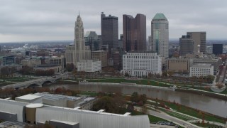 5.7K aerial stock footage of flying by the city's skyline across the Scioto River, Downtown Columbus, Ohio Aerial Stock Footage | DX0001_002718