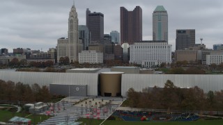 DX0001_002724 - 5.7K aerial stock footage descend by science museum with view of the city skyline, Downtown Columbus, Ohio