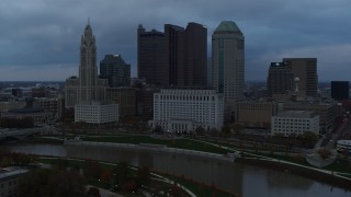 5.7K aerial stock footage stationary view of the city skyline and the Scioto River at sunset, Downtown Columbus, Ohio Aerial Stock Footage | DX0001_002750