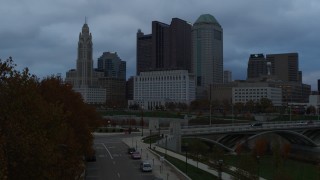 5.7K aerial stock footage of the city skyline and the Scioto River at sunset during descent, Downtown Columbus, Ohio Aerial Stock Footage | DX0001_002752