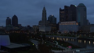 5.7K aerial stock footage ascend by the river with view of city skyline at twilight in Downtown Columbus, Ohio Aerial Stock Footage | DX0001_002767